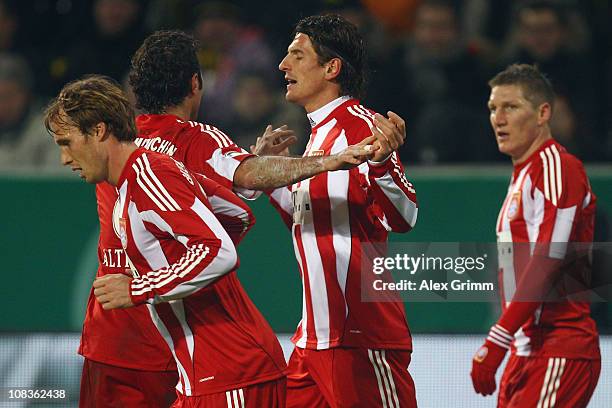 Mario Gomez of Muenchen celebrates his team's first goal with team mates Andreas Ottl, Hamit Altintop and Bastian Schweinsteiger during the DFB Cup...