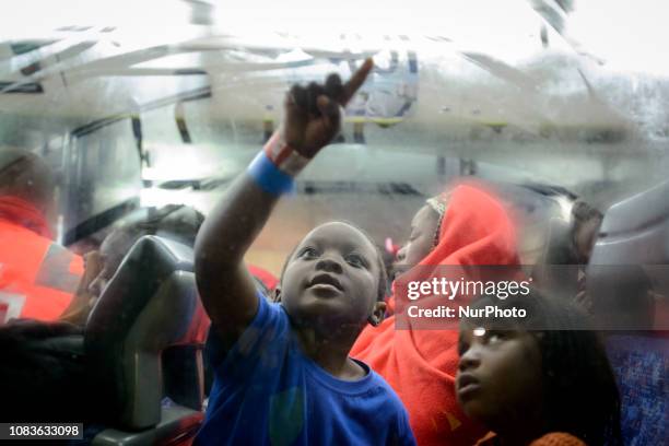 Young boy draws on the window inside a bus to be transferred to a center. Since the beginning of the year 2019, around 1300 rescued migrants have...