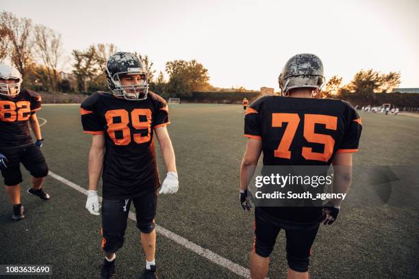 football players on field - sports jersey back stock pictures, royalty-free photos & images