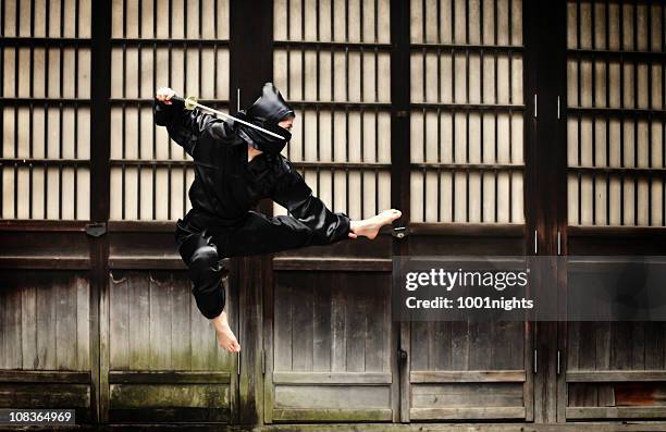 asian woman showing her ninja moves - ninja stock pictures, royalty-free photos & images