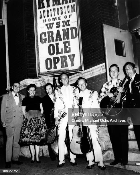 Hall Willis, Ginger Willis and Tommy Hill stand next to Ira Louvin and Charlie Louvin of the country brothers duo "The Louvin Brothers" as they pose...
