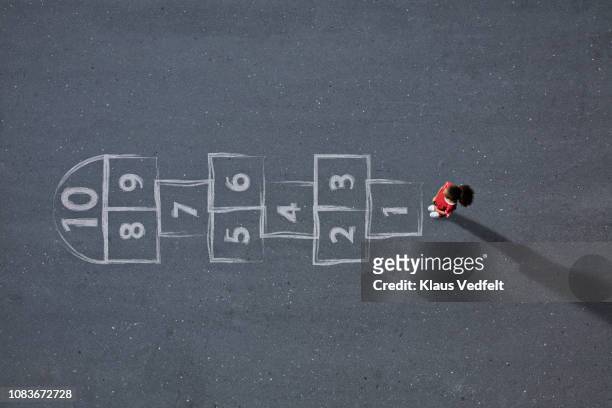 school girl standing in front big hopscotch - aerial view of childs playground stock pictures, royalty-free photos & images