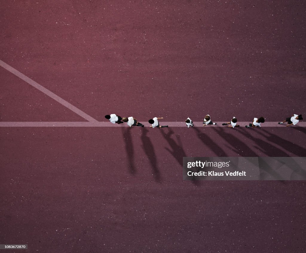 School children in uniforms walking in row on line with crossroad