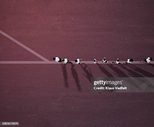 school children in uniforms walking in row on line with crossroad - 分かれ道 ストックフォトと画像