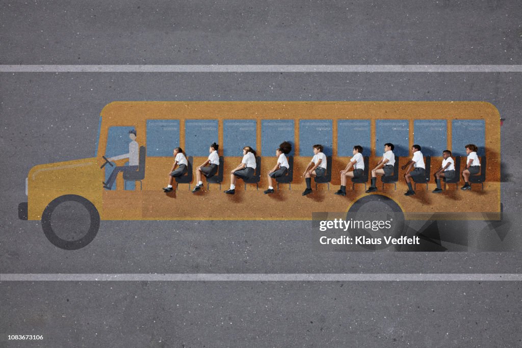 School children in uniforms "sitting" in school bus