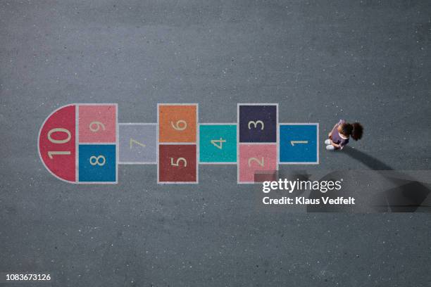 school girl standing in front big hopscotch - comienzo fotografías e imágenes de stock