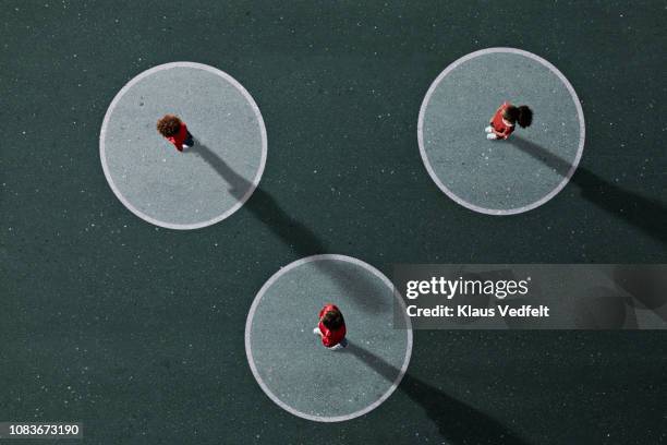 school children in uniforms standing on painted venn diagrams - aerial people circle stock pictures, royalty-free photos & images