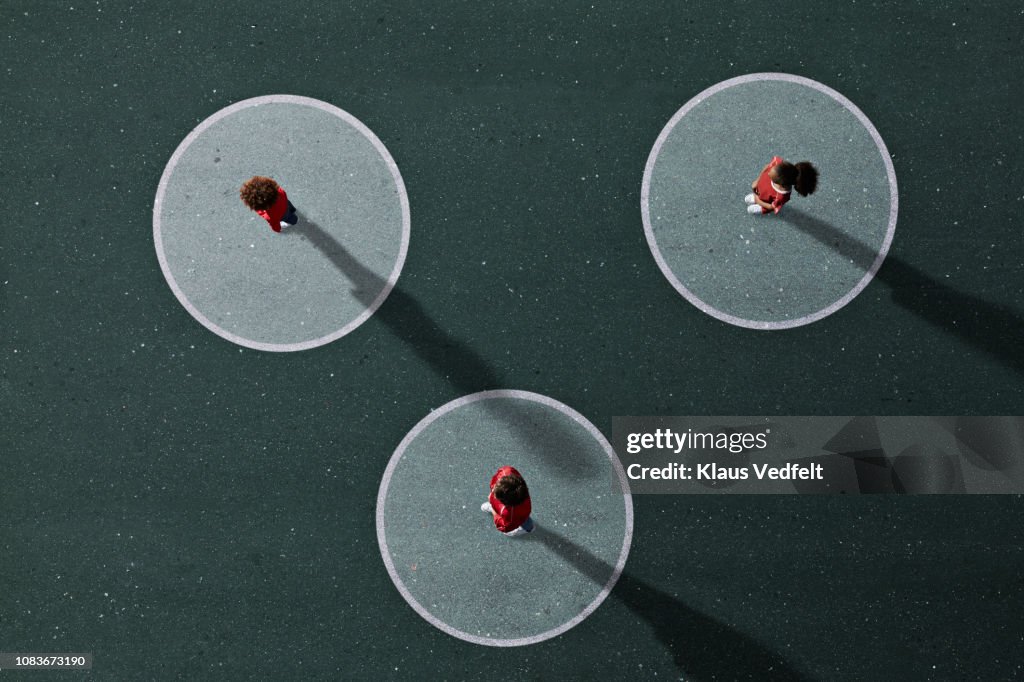 School children in uniforms standing on painted Venn Diagrams