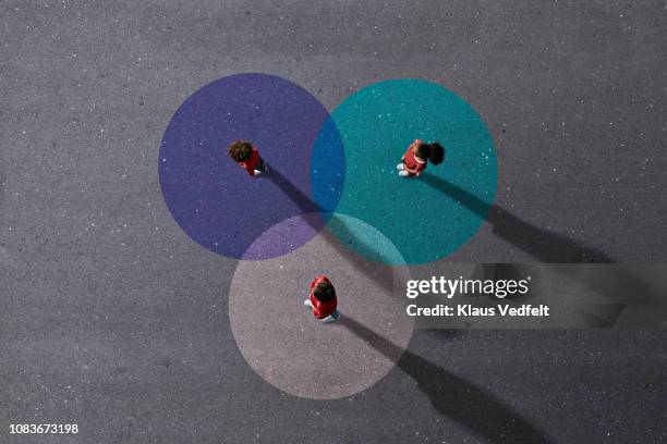 school children in uniforms standing on painted venn diagrams - colour selection foto e immagini stock