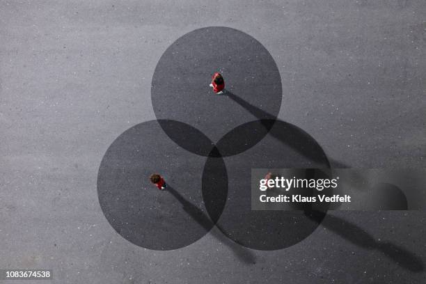 school children in uniforms standing on painted venn diagrams - venn diagramm stock-fotos und bilder