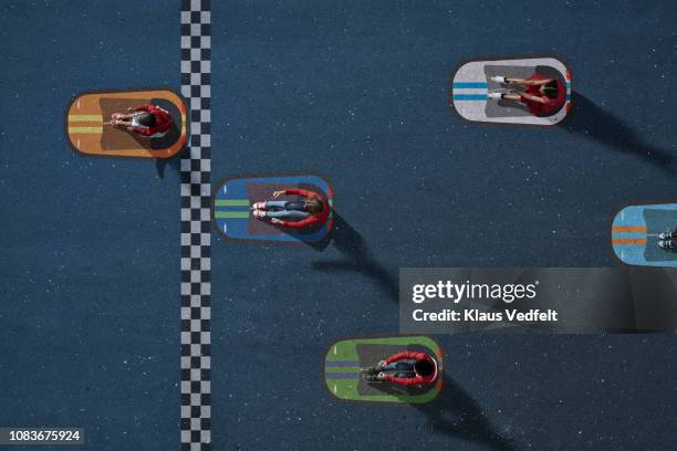 children sitting in painted imaginary bumper cars - five people stock-fotos und bilder