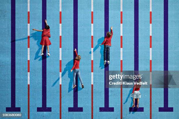 children swimming in imaginary painted pool with lanes - swimming race imagens e fotografias de stock