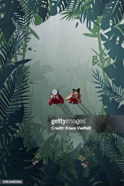 girl & boy standing on painted imaginary jungle scenery with cameras - jungle safari stock pictures, royalty-free photos & images