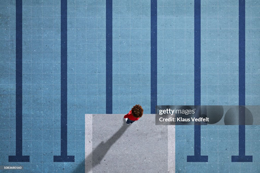 Child standing on painted imaginary pool & diving platform