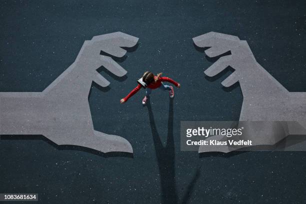 girl wearing vr goggles walking on background with painted hands - threats fotografías e imágenes de stock