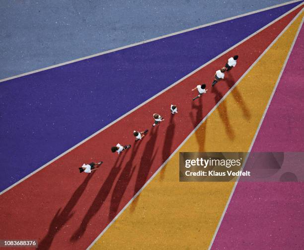 school children in uniforms walking in row on multi coloured background - art direction stock pictures, royalty-free photos & images