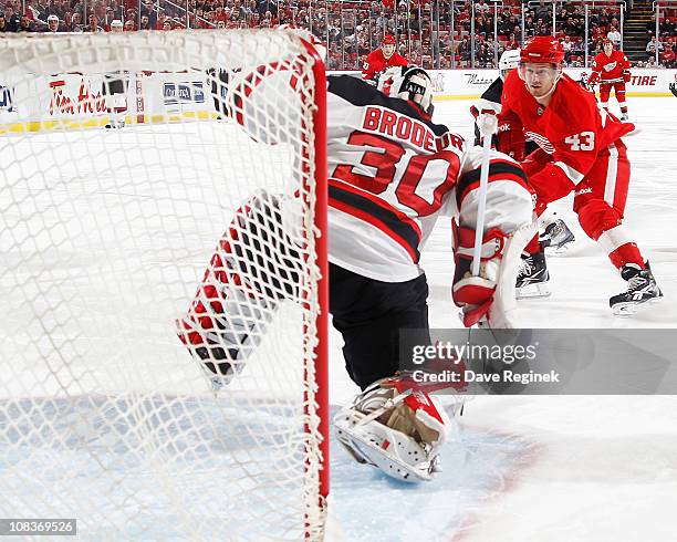 Darren Helm of the Detroit Red Wings scores a goal on Martin Brodeur of the New Jersey Devils during an NHL game at Joe Louis Arena on January 26,...