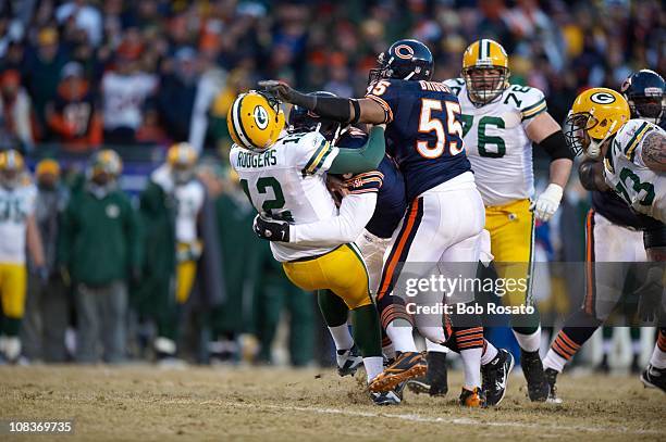 Championship: Green Bay Packers QB Aaron Rodgers in action during tackle by Chicago Bears Julius Peppers at Soldier Field. Peppers received penalty...