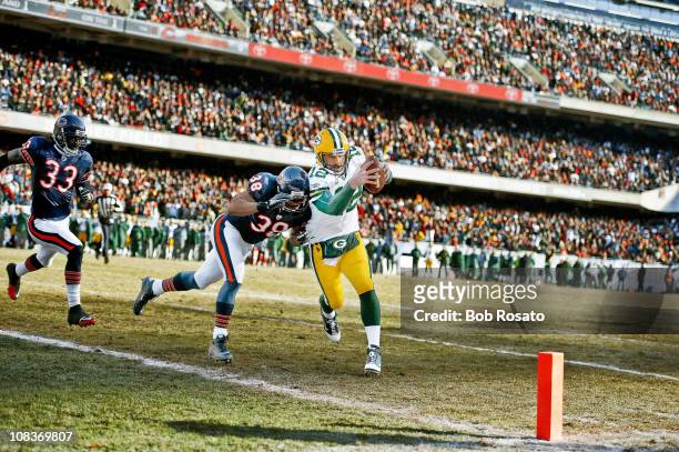 Championship: Green Bay Packers QB Aaron Rodgers in action, scoring touchdown vs Chicago Bears Danieal Manning during 1st quarter at Soldier Field....