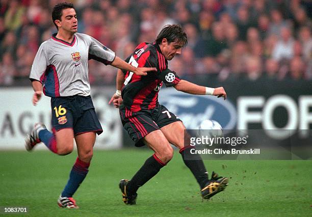 Francesco Coco of AC Milan is challenged by Xavi of Barcelona during the UEFA Champions League match at the San Siro in Milan, Italy. The match was...