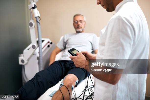 tens therapy - electrode stock pictures, royalty-free photos & images