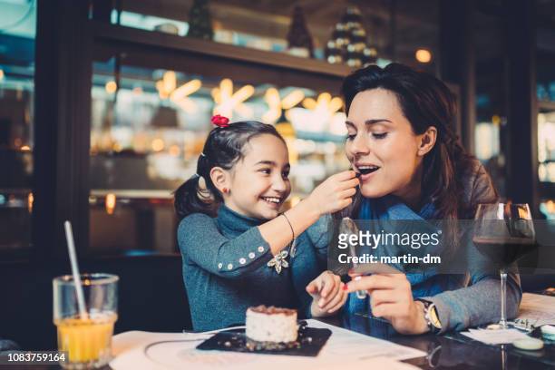 family eating in restaurant - children restaurant stock pictures, royalty-free photos & images