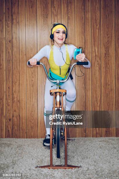 retro style exercise bike woman eighties era - retro hairstyle stock pictures, royalty-free photos & images