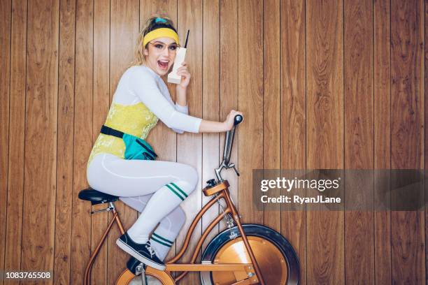 retro style exercise bike woman eighties era brick phone - funny looking at phone stock pictures, royalty-free photos & images