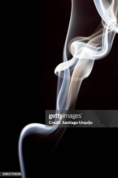 incense smoke against a black background - wispy stock pictures, royalty-free photos & images