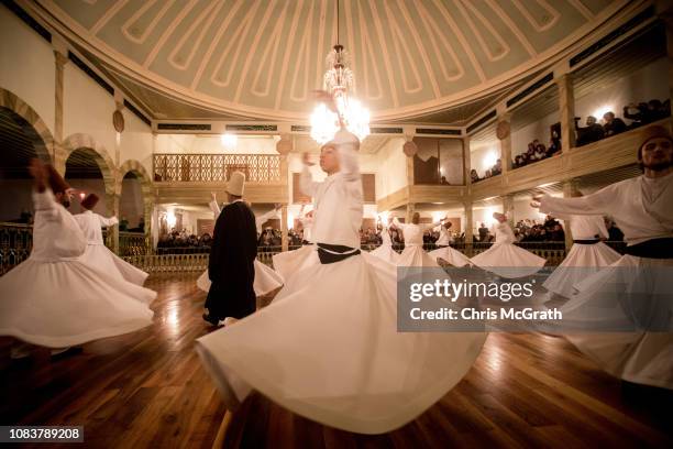 Whirling Dervishes take part in a Sema Prayer Ceremony at the Yenikapi Mevlevihanesi marking the anniversary of the death of Mevlana Jalal al-Din...