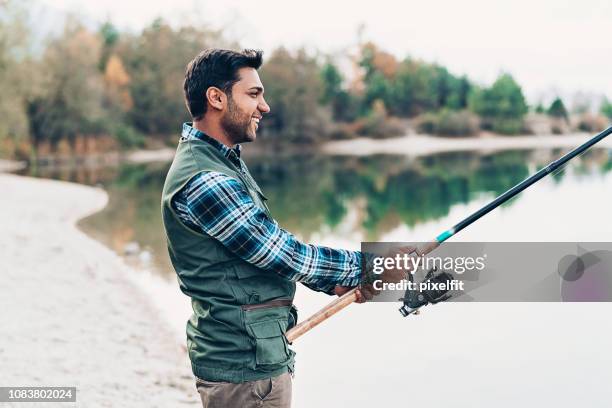 young man fishing - fisherman isolated stock pictures, royalty-free photos & images