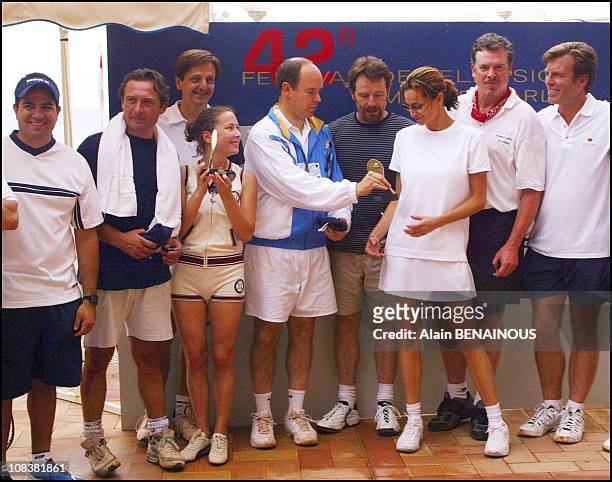 Prince Albert offers trophy to his friend Alexandra Kamp in Monaco on July 06, 2002.