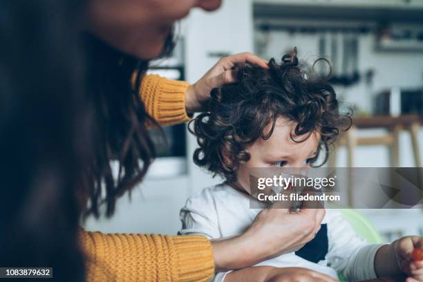 mother helping son to blow his nose - cold virus stock pictures, royalty-free photos & images