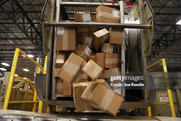 Packages are seen as they are sorted at the U.S. Postal service's Royal Palm Processing and Distribution Center on December 17, 2018 in Opa Locka,...