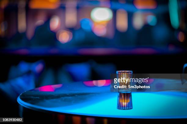 nightclub bar scene of abstract nightlife with candle and table at restaurant - night club stock-fotos und bilder