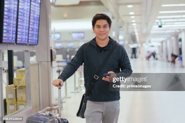 young asian japanese man travel by public transportation and waiting for plane in  airport japan - narita city stock pictures, royalty-free photos & images