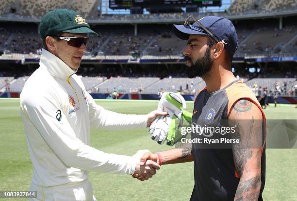 Tim Paine of Australia shakes hands with Virat Kohli of India after Australia claimed victory during day five of the second match in the Test series...