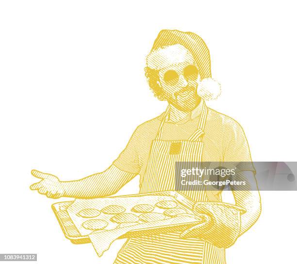 young man wearing santa hat baking cookies - man baking stock illustrations