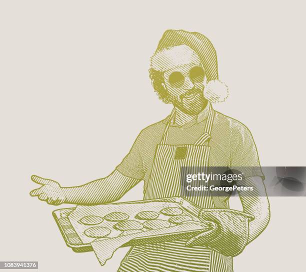 stockillustraties, clipart, cartoons en iconen met jonge man dragen kerstmuts bakken koekjes - kerstman cool