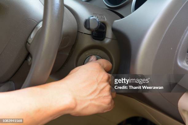 man hand on turn key on start the car - car engine close up stock pictures, royalty-free photos & images