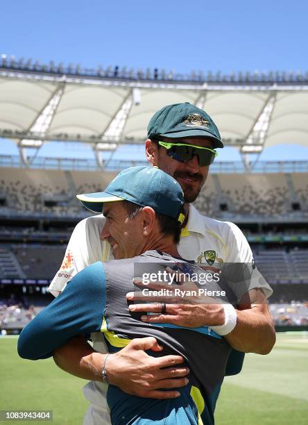 Justin Langer, coach of Australia, celebrates with Mitchell Starc of Australia after day five of the second match in the Test series between...