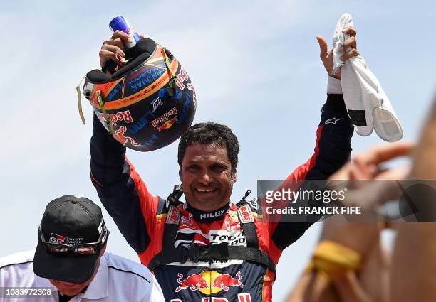 Toyota's driver Nasser Al-Attiyah of Qatar celebrates after winning the Dakar Rally 2019, at the end of the last stage between Pisco and Lima, in...