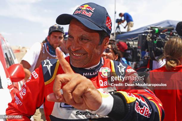 Toyota Gazoo Racing Sa no. 301 TOYOTA HILUX car driven by Nasser Al-Attiyah of Qatar and Matthieu Baumel of France celebrates as he crosses the...