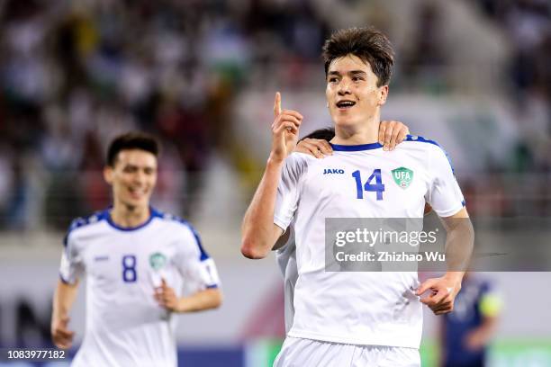 Eldor Shomurodov of Uzbekistan celebrates his scoring with teammates during the AFC Asian Cup Group F match between Japan and Uzbekistsn at Khalifa...