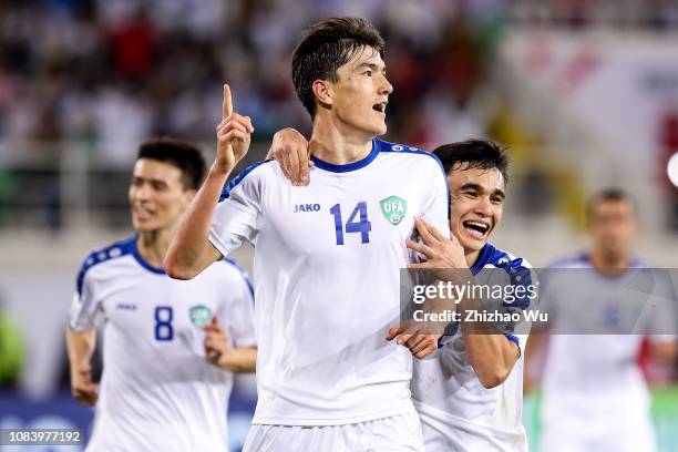 Eldor Shomurodov of Uzbekistan celebrates his scoring with teammates during the AFC Asian Cup Group F match between Japan and Uzbekistsn at Khalifa...