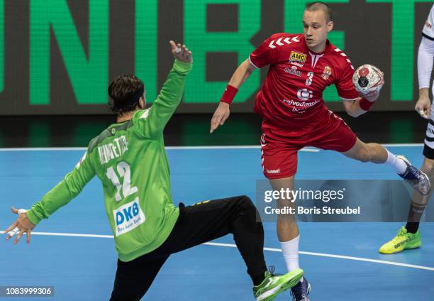 Vukasin Vorkapic of Serbia scores against goalkeeper Silvio Heinevetter of Germany during the 26th IHF Men's World Championship group A match between...