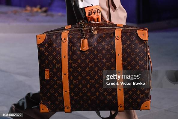 Louis Vuitton cylinder shaped monogrammed bag photographed on a white  background Stock Photo - Alamy
