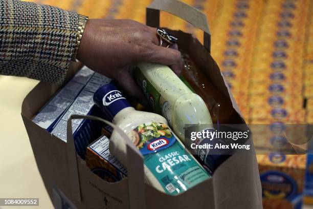 Furloughed federal worker bags free food at a pop-up store of Kraft Heinz January 17, 2019 in Washington, DC. Kraft Heinz opened a store to...