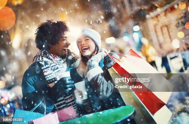 couple doing some street shopping. - christmas shopping stock pictures, royalty-free photos & images