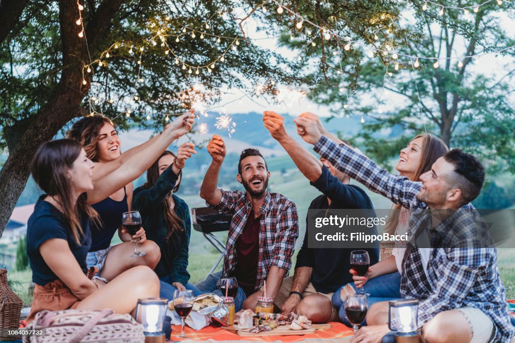 Happy friends having fun together with sparklers